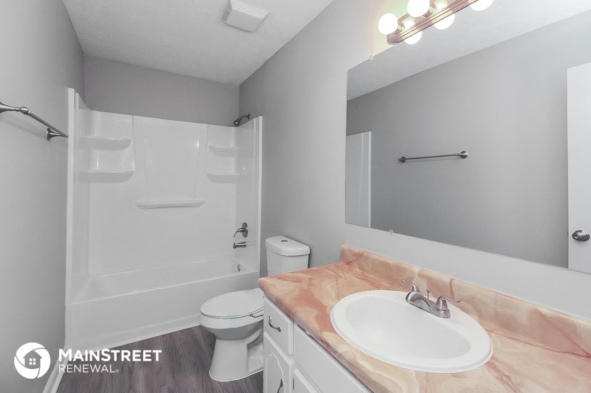 a bathroom with a sink and a toilet and a shower