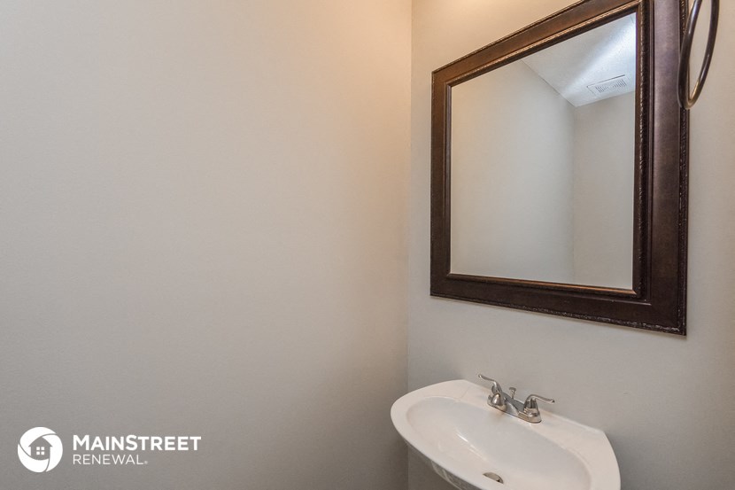 a small bathroom with a sink and a mirror