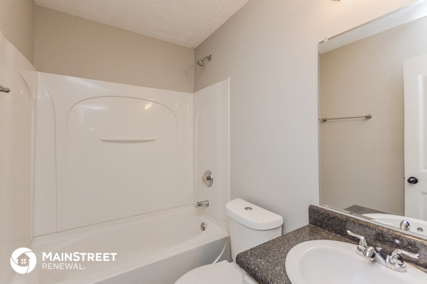 a bathroom with a sink and a toilet and a bath tub