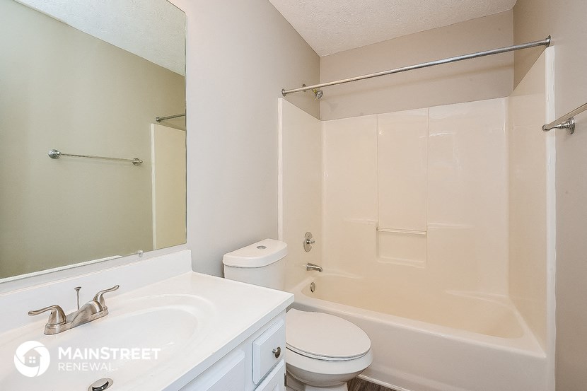 a bathroom with a sink toilet and a tub