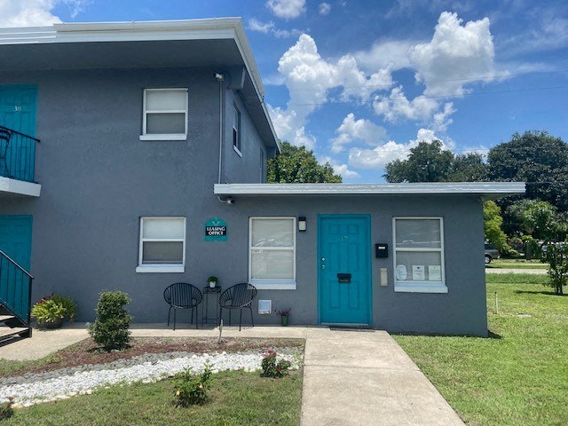 a blue house with a blue door and a sidewalk