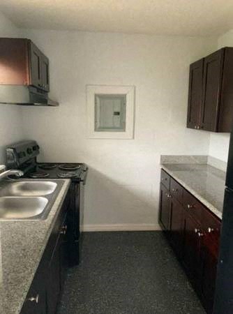 a small kitchen with a stove and a sink