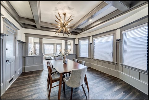 a dining room with a table and chairs and a chandelier