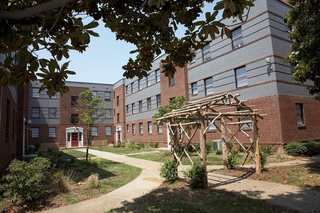 a walkway in front of a brick building