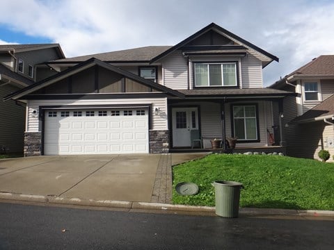 a house with a white garage door in front of it