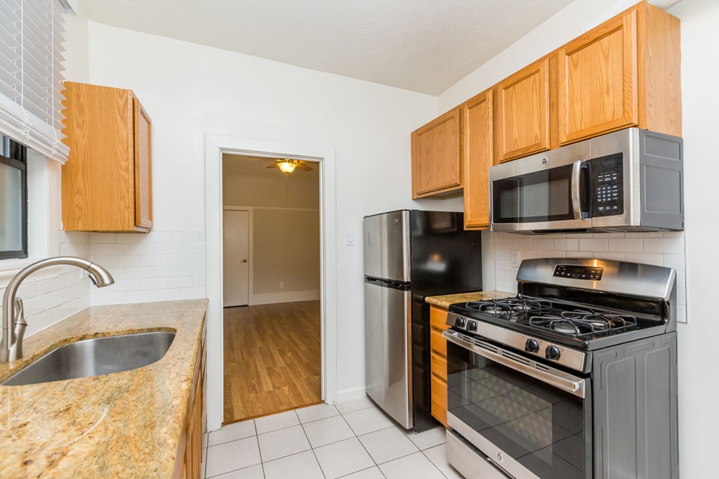 a kitchen with stainless steel appliances and wooden cabinets