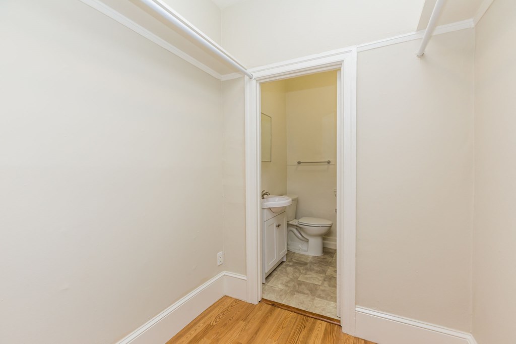 a room with a toilet and a door to a bathroom