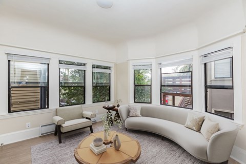 A living room with a white couch and a coffee table.