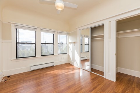 A room with a wooden floor and a ceiling fan.