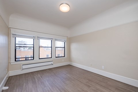 Empty room with a window and a light on the ceiling.