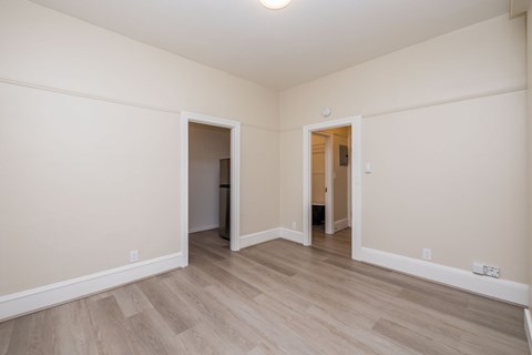 A room with a wooden floor and white walls.