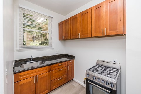 A kitchen with a stove and cabinets.