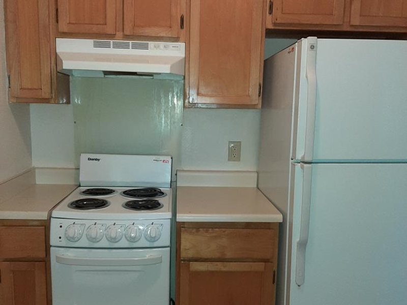 a kitchen with a stove and a refrigerator