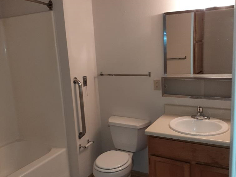 a bathroom with a toilet and a sink and a shower