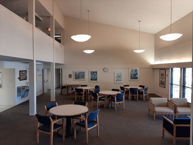 a large dining room with tables and chairs in a hall