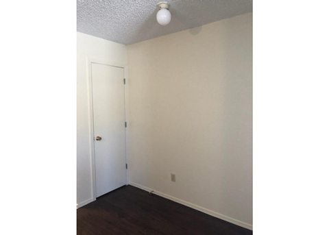 A room with a door and a light on the ceiling.