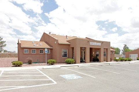 A building with a parking lot in front of it.