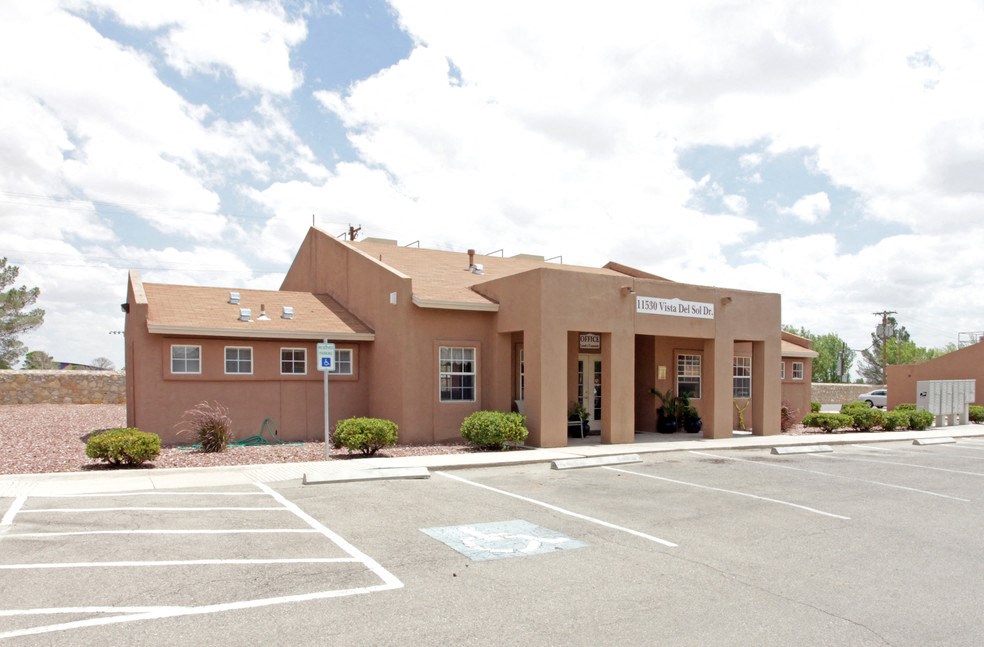 A building with a parking lot in front of it.