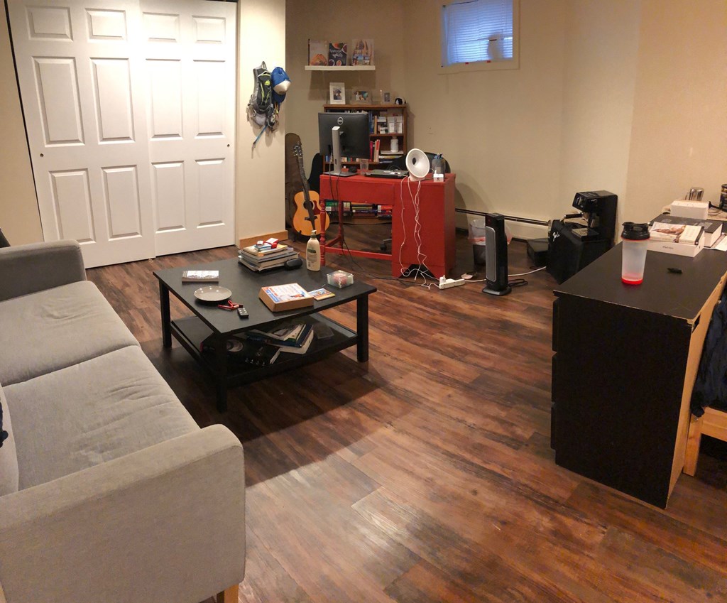 a living room with a couch and a table and a tv