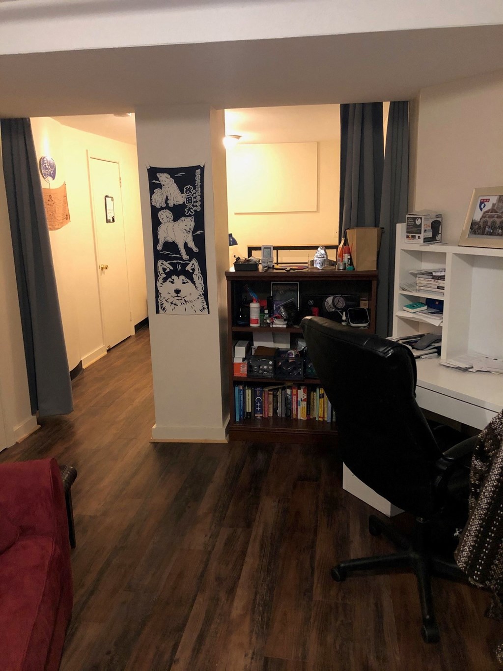 a living room with a desk and a chair