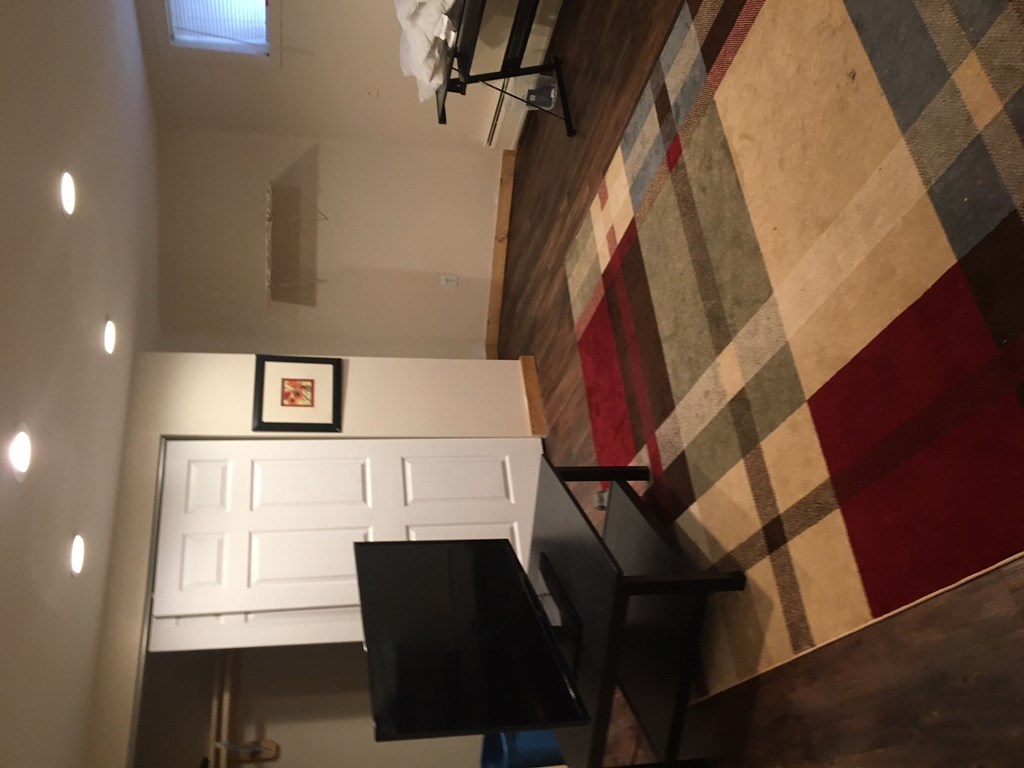 a view from the top of the stairs looking down into the living room