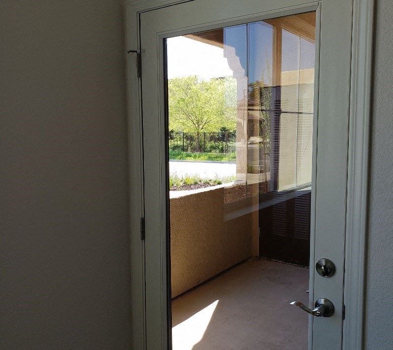 a door that is open to a balcony with a window