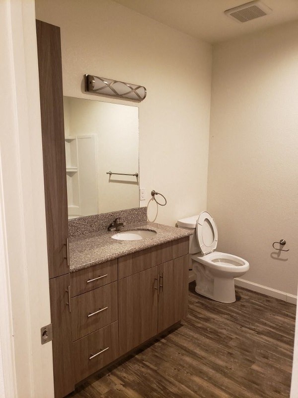 a bathroom with a toilet and a sink and a mirror