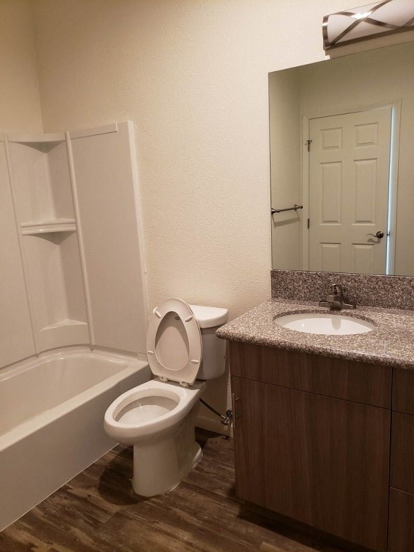a bathroom with a toilet and a sink and a bath tub