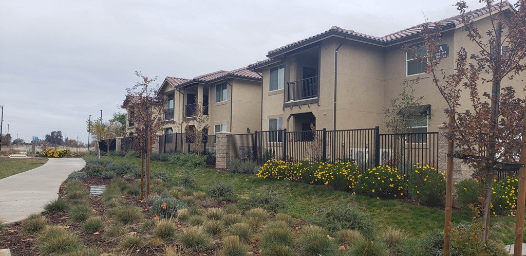 a row of houses with a sidewalk in front of them