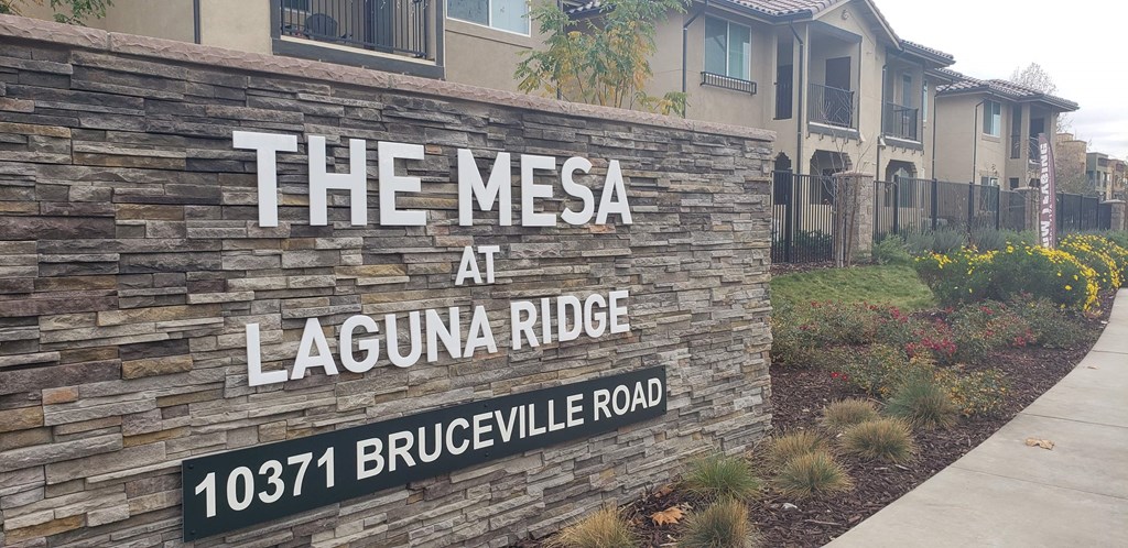 the mesa at laguna ridge sign on a stone wall