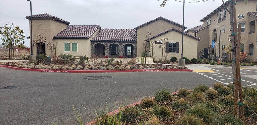 a house with a parking lot and a street in front of it