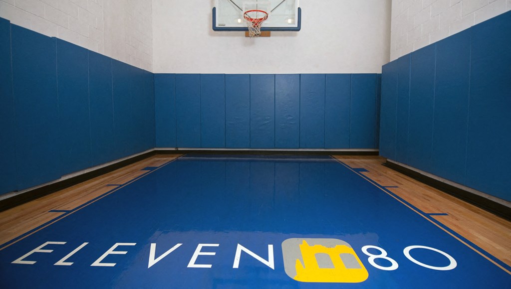 Indoor basketball court with property logo on floor