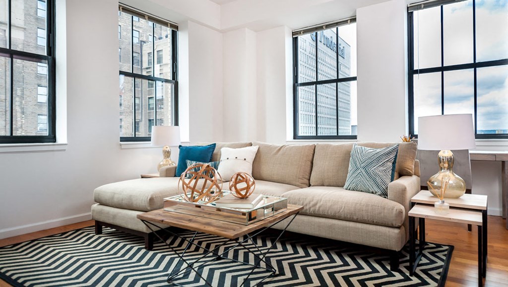 Newark NJ Apartments-Eleven80 Apartments Living Room With Wood-Style Flooring And Multiple Windows With City View