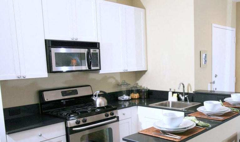 Newark Apartments-Eleven80 Apartments Kitchen With Split Square Tile And Wood-Style Flooring And Breakfast Bar With Seating - Photo Gallery