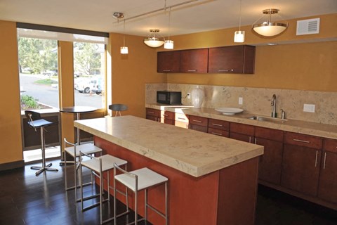 a kitchen with a marble counter top and some bar stools