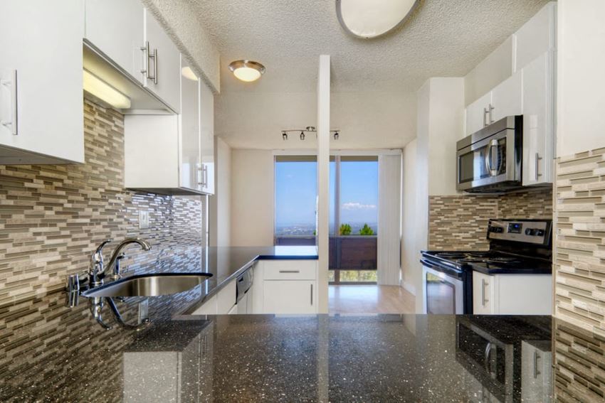 a kitchen with a counter top and a sink