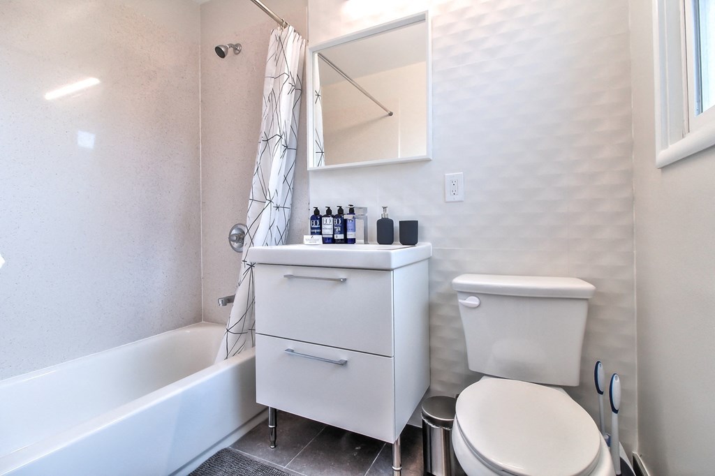 a small bathroom with a toilet and a bath tub