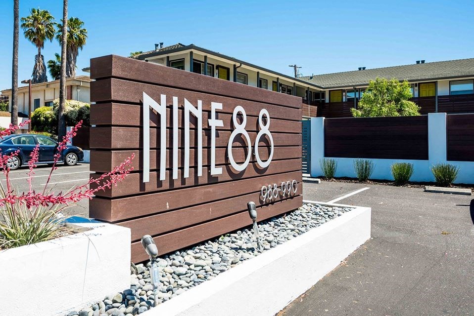 a sign in a parking lot in front of a building