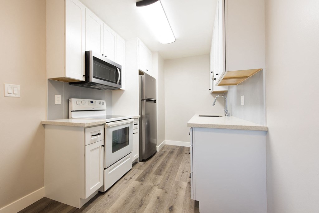 a kitchen with white appliances and white cabinets