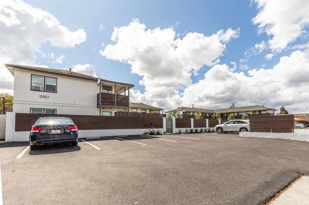 a car parked in a parking lot in front of a house