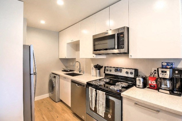 a kitchen with stainless steel appliances and a microwave