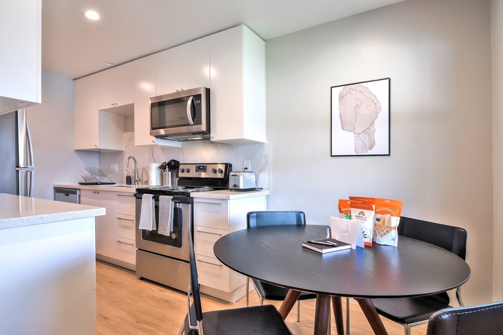 a kitchen and dining room with a table and chairs