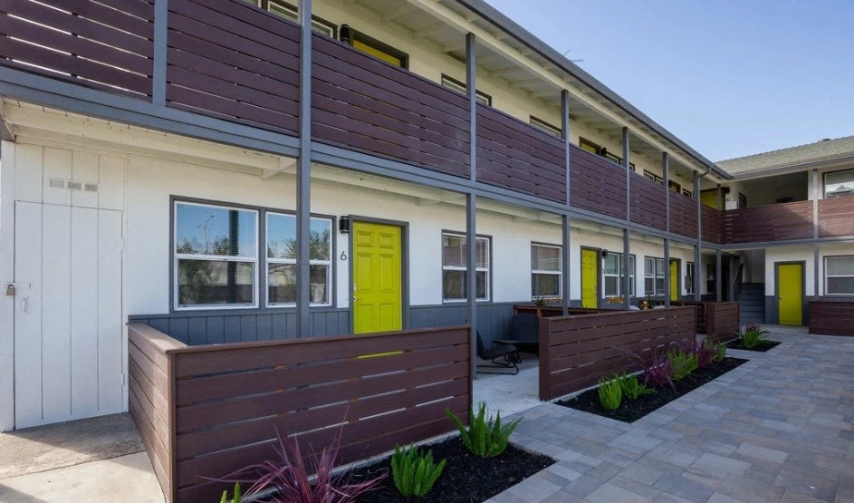the front of a building with a yellow door