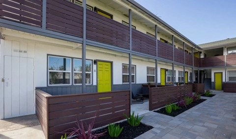 the front of a building with a yellow door