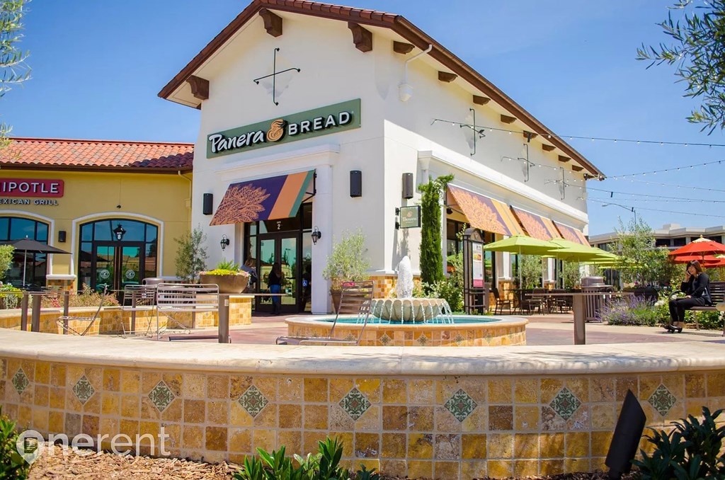 a fountain in front of a restaurant with a building