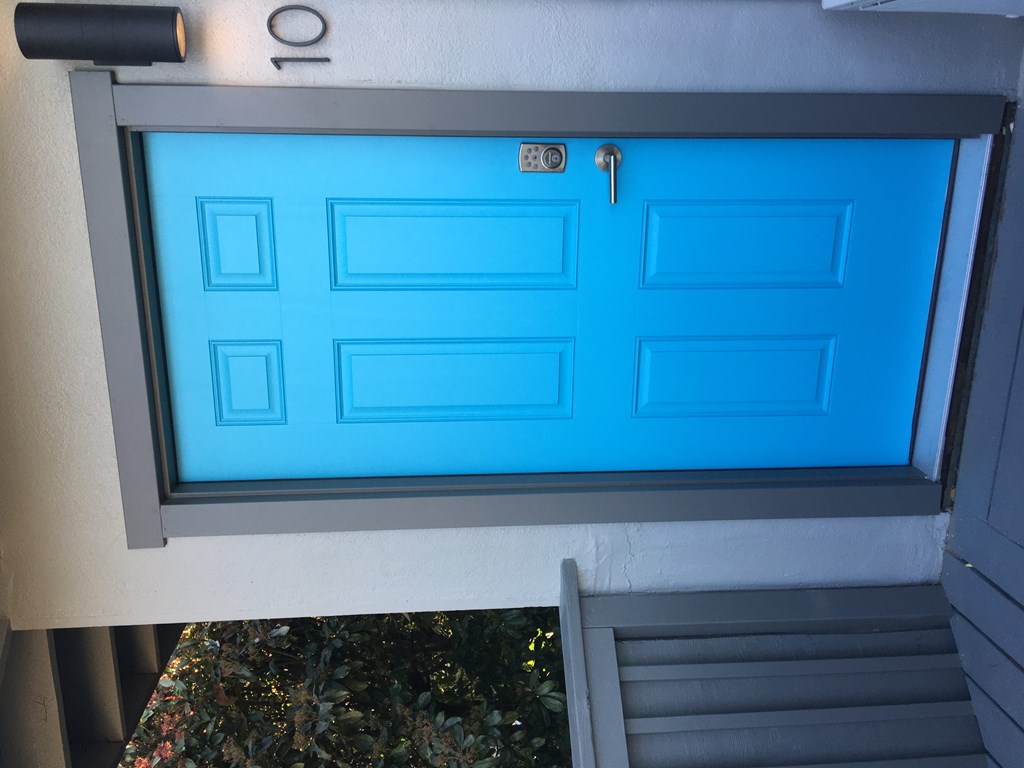 a blue door on the side of a house