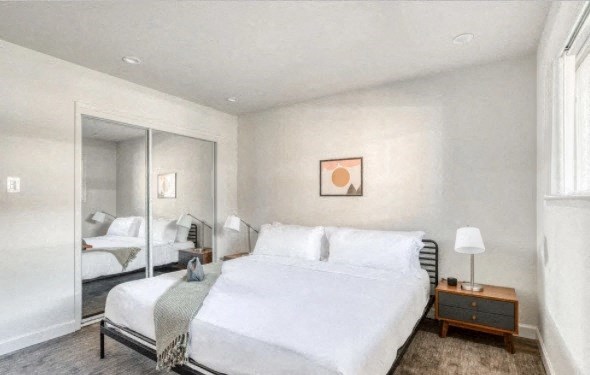 a bedroom with a bed and a mirror