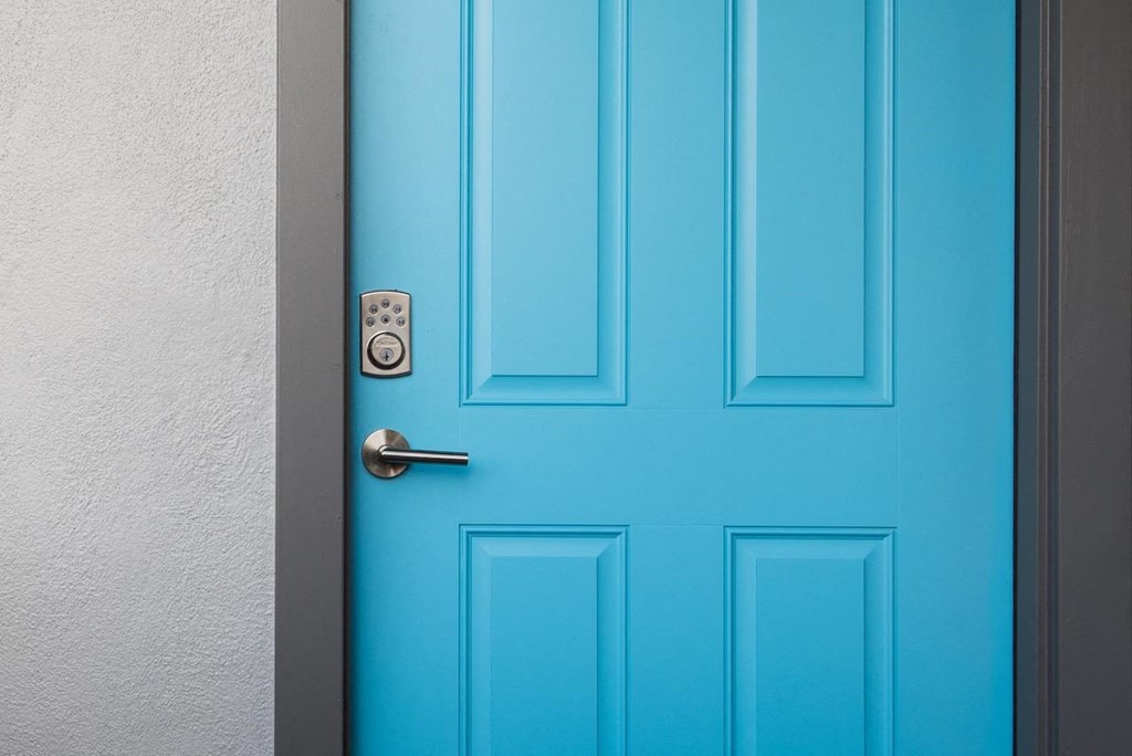 a blue door with a silver door handle