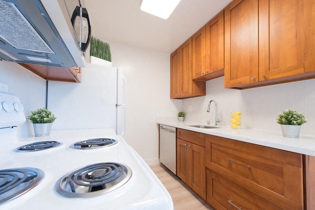a kitchen with white appliances and wooden cabinets