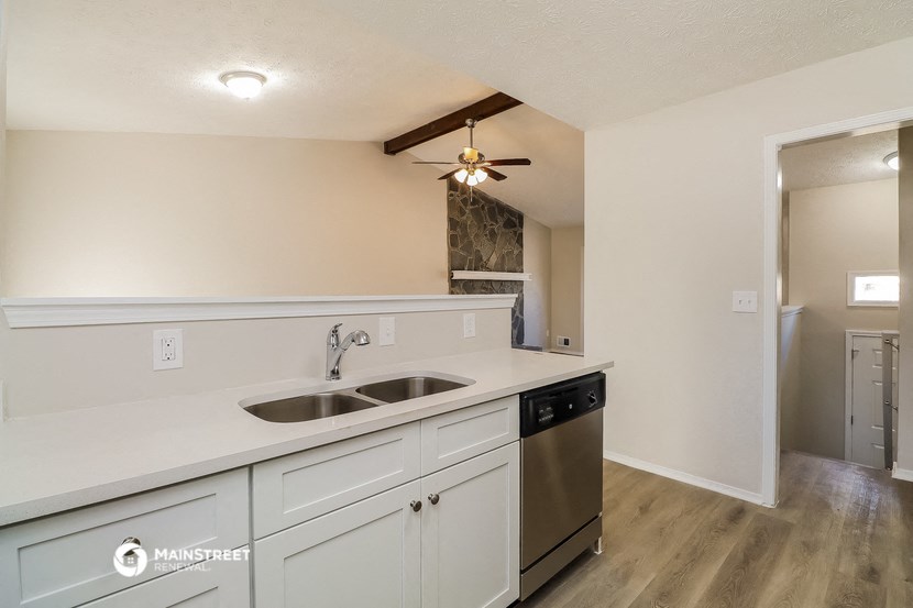 the kitchen of our studio apartment atrium with stainless steel appliances and a ceiling fan